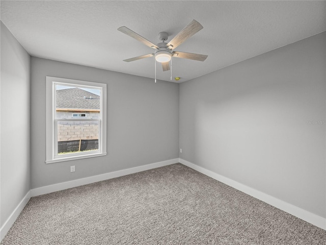 spare room featuring a ceiling fan, carpet flooring, a textured ceiling, and baseboards