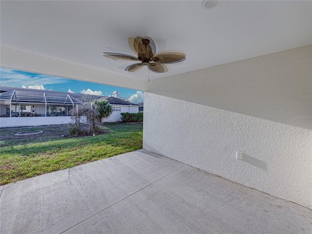 view of patio / terrace with ceiling fan and glass enclosure