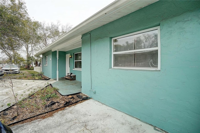 view of side of property featuring a patio area and stucco siding