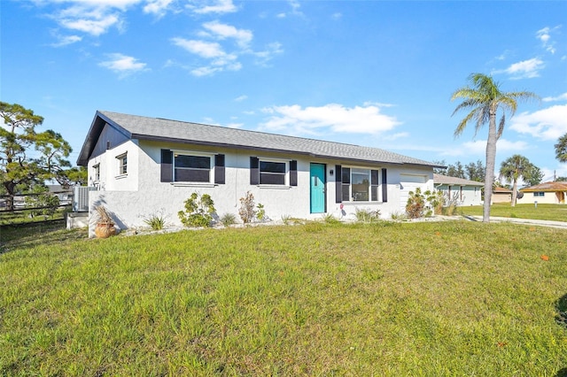 ranch-style home with stucco siding, central AC, and a front yard