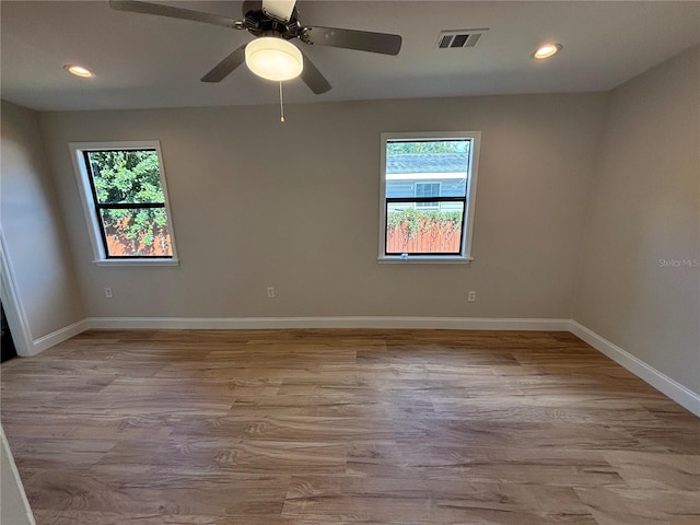 empty room with recessed lighting, visible vents, light wood finished floors, and baseboards