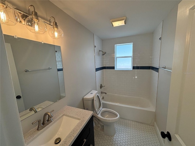 bathroom with toilet, vanity,  shower combination, tile patterned flooring, and baseboards