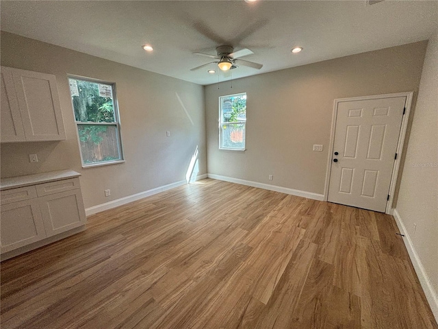 interior space featuring recessed lighting, light wood-style flooring, and baseboards