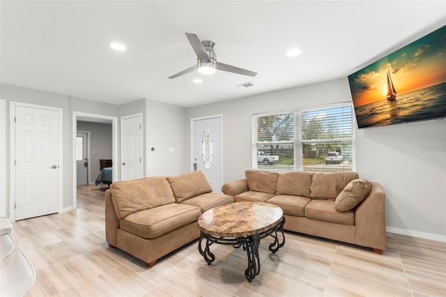 living room featuring a ceiling fan, recessed lighting, visible vents, and baseboards