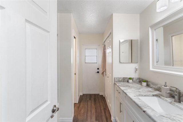 bathroom featuring vanity, a textured ceiling, and wood finished floors