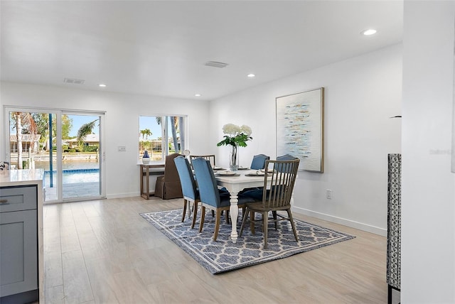 1984 Kansas Ave NE, Saint Petersburg, FL 33703 - dining area with light wood-type flooring, visible vents, baseboards, and recessed lighting
