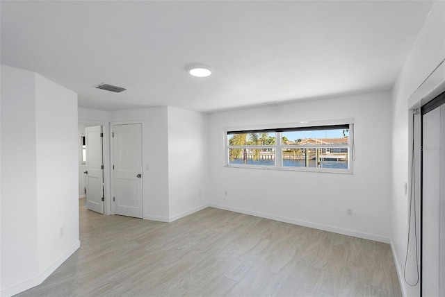 1984 Kansas Ave NE, Saint Petersburg, FL 33703 - unfurnished room featuring light wood-style floors, baseboards, and visible vents