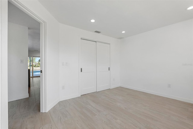 1984 Kansas Ave NE, Saint Petersburg, FL 33703 - unfurnished bedroom with light wood finished floors, recessed lighting, visible vents, and baseboards