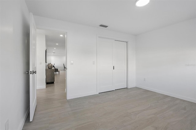 1984 Kansas Ave NE, Saint Petersburg, FL 33703 - unfurnished bedroom featuring light wood-style flooring, visible vents, baseboards, and recessed lighting