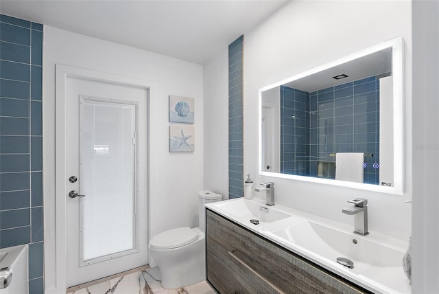 1984 Kansas Ave NE, Saint Petersburg, FL 33703 - bathroom featuring toilet, a sink, marble finish floor, double vanity, and walk in shower
