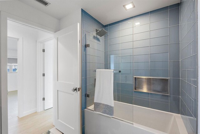 1984 Kansas Ave NE, Saint Petersburg, FL 33703 - bathroom with  shower combination, wood finished floors, and visible vents