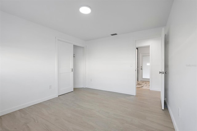 1984 Kansas Ave NE, Saint Petersburg, FL 33703 - unfurnished room with light wood finished floors and baseboards