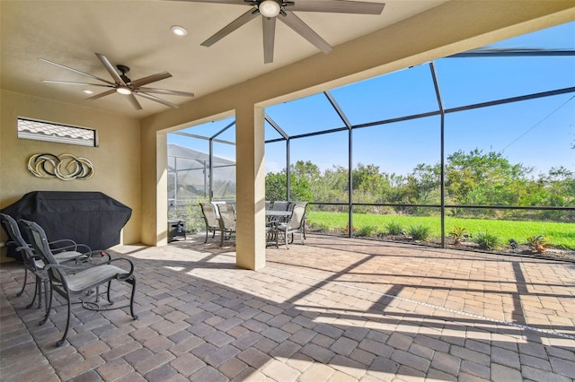 view of patio / terrace with a mountain view, outdoor dining area, a lanai, and a ceiling fan