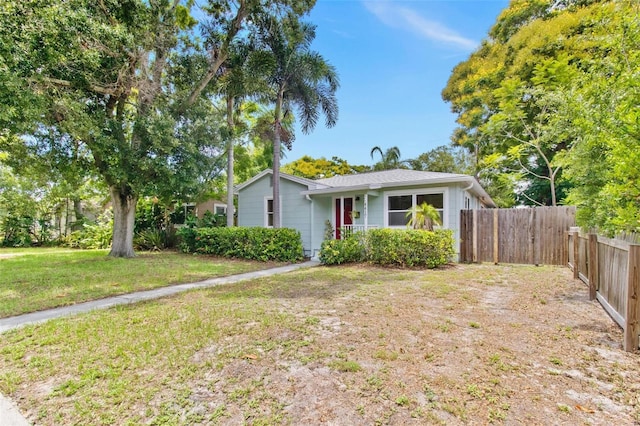 view of front of house with fence and a front yard