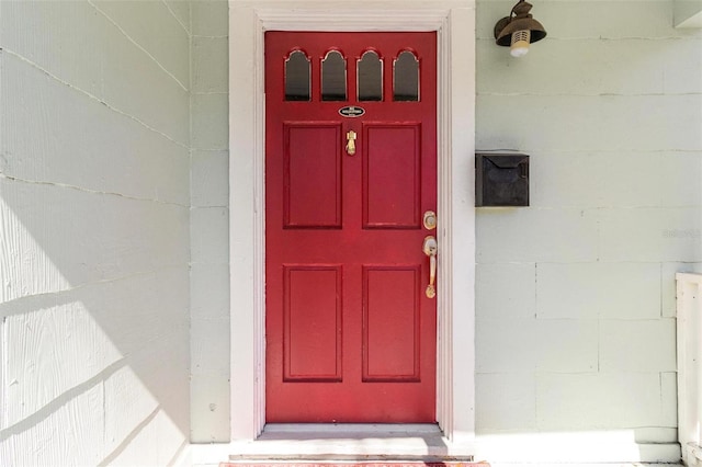 doorway to property featuring concrete block siding