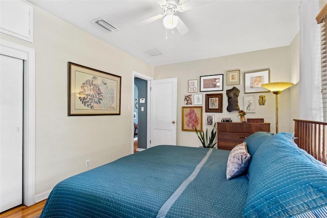 bedroom with a ceiling fan, visible vents, and light wood-style floors