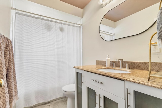 full bath with toilet, tile patterned flooring, and vanity