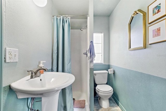 full bathroom featuring a stall shower and toilet