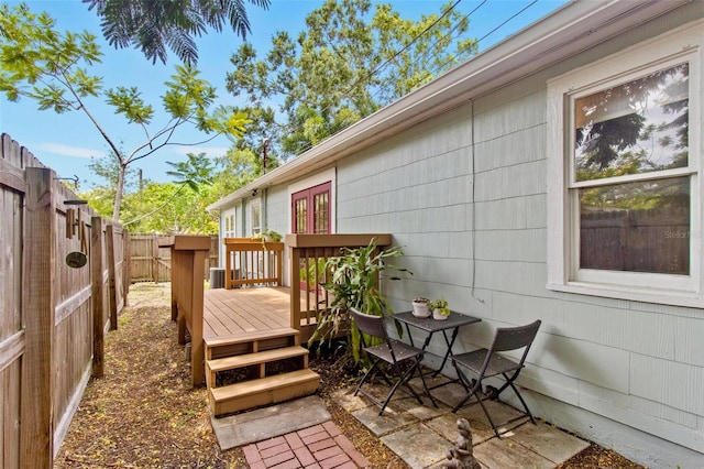 wooden deck with a fenced backyard