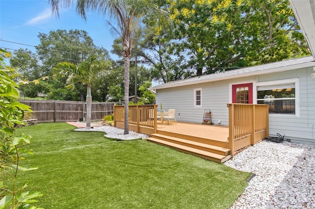 view of yard featuring fence and a wooden deck