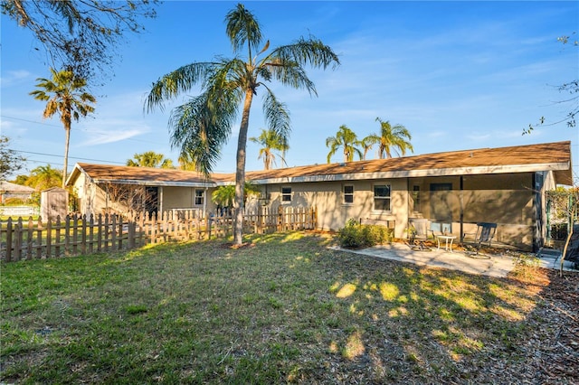 back of house with a yard and fence