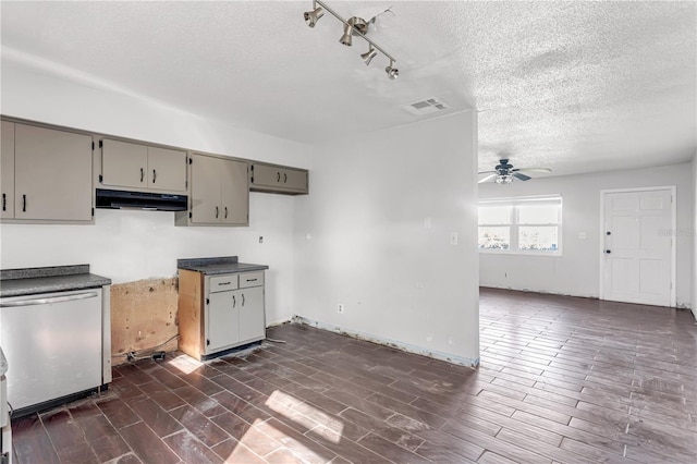 kitchen featuring gray cabinetry, refrigerator, under cabinet range hood, visible vents, and dishwasher