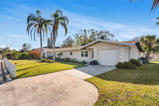 ranch-style house with stucco siding, concrete driveway, an attached garage, fence, and a front lawn