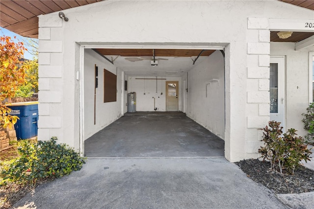 garage with water heater and a garage door opener