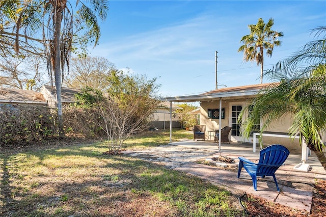 view of yard with fence and a patio