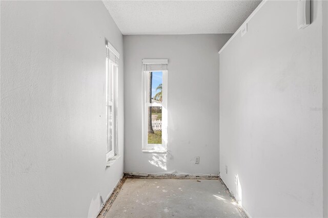 unfurnished room with a textured ceiling