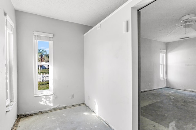 spare room featuring a textured ceiling and visible vents