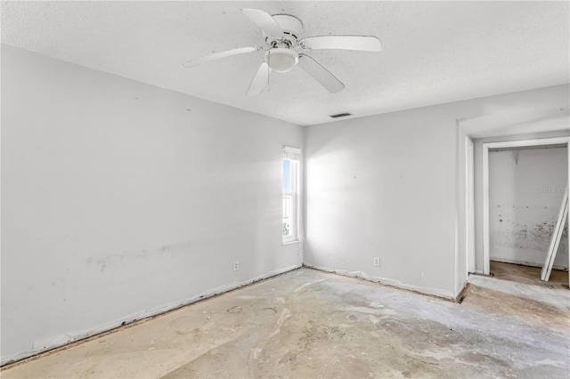 unfurnished bedroom with a textured ceiling, ceiling fan, and visible vents