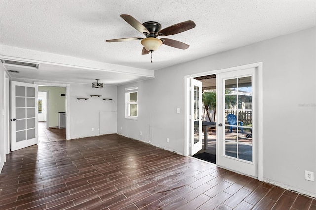 unfurnished room with visible vents, ceiling fan, a textured ceiling, french doors, and wood finish floors