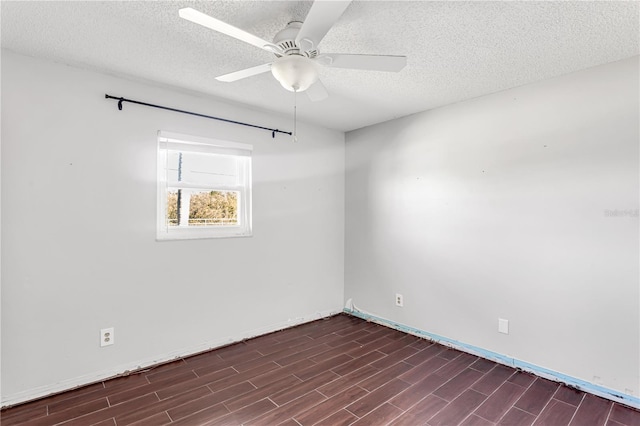 spare room featuring wood tiled floor, ceiling fan, and a textured ceiling