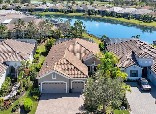 birds eye view of property with a water view and a residential view