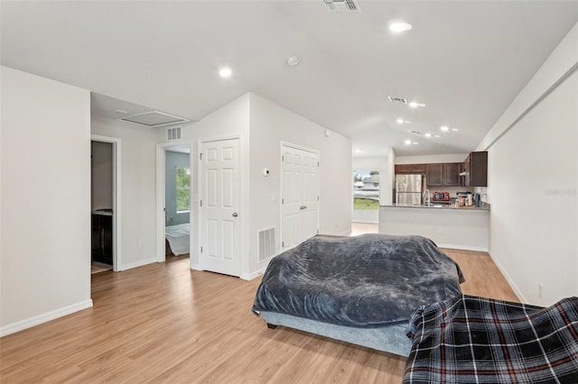 interior space with lofted ceiling, recessed lighting, visible vents, and light wood-style floors