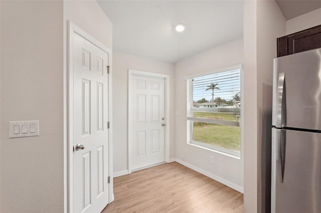 interior space featuring baseboards and light wood-style floors