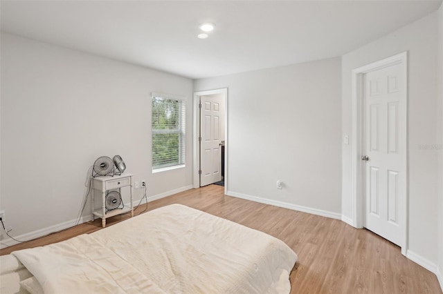 bedroom with baseboards and wood finished floors