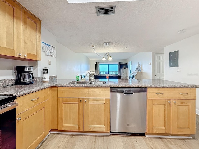 kitchen featuring visible vents, a peninsula, stainless steel dishwasher, light wood-style floors, and a sink