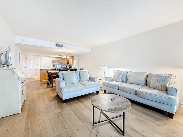living room featuring visible vents and light wood-style floors