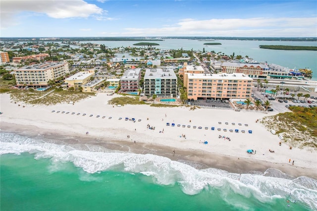 bird's eye view with a water view, a view of the beach, and a city view