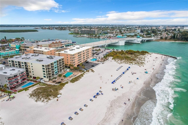 birds eye view of property featuring a water view, a view of the beach, and a city view
