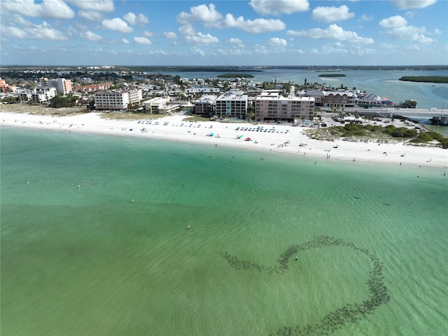 drone / aerial view with a water view, a view of the beach, and a city view