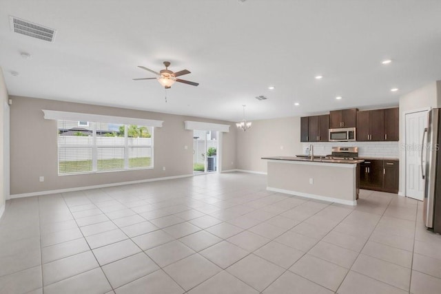 kitchen with open floor plan, stainless steel appliances, light tile patterned flooring, and visible vents