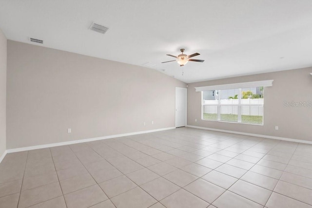 empty room featuring ceiling fan, visible vents, baseboards, and light tile patterned flooring