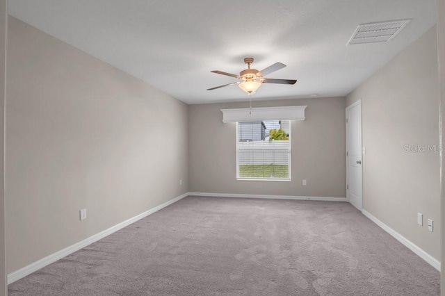 unfurnished room with a ceiling fan, carpet, visible vents, and baseboards