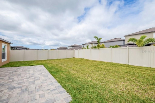 view of yard with a patio and a fenced backyard