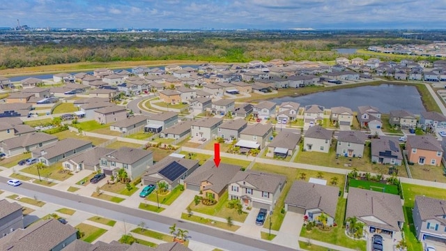 birds eye view of property with a water view and a residential view