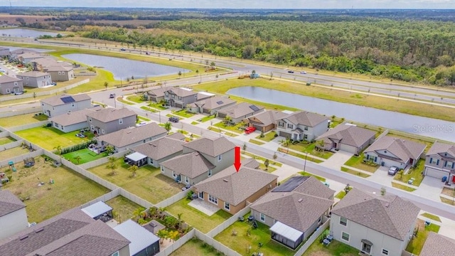 bird's eye view with a water view and a residential view