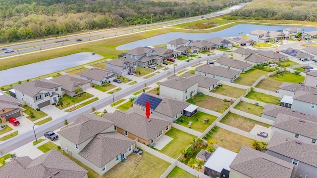 drone / aerial view with a residential view and a water view